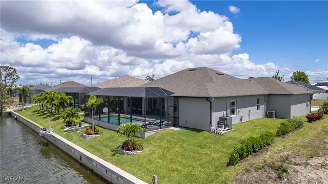 a view of a house with backyard and sitting area