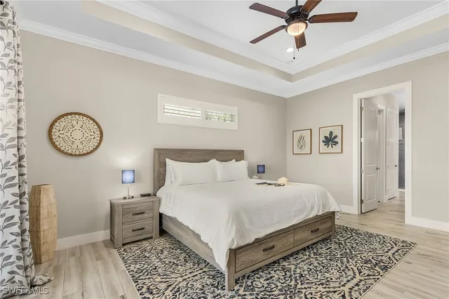 a bedroom with a bed and painting on the wall