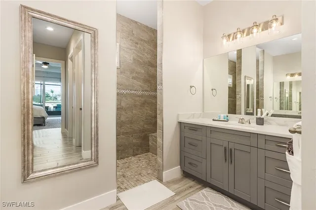 a bathroom with a double vanity sink mirror and shower