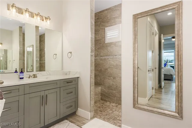 a bathroom with a double vanity sink mirror and shower