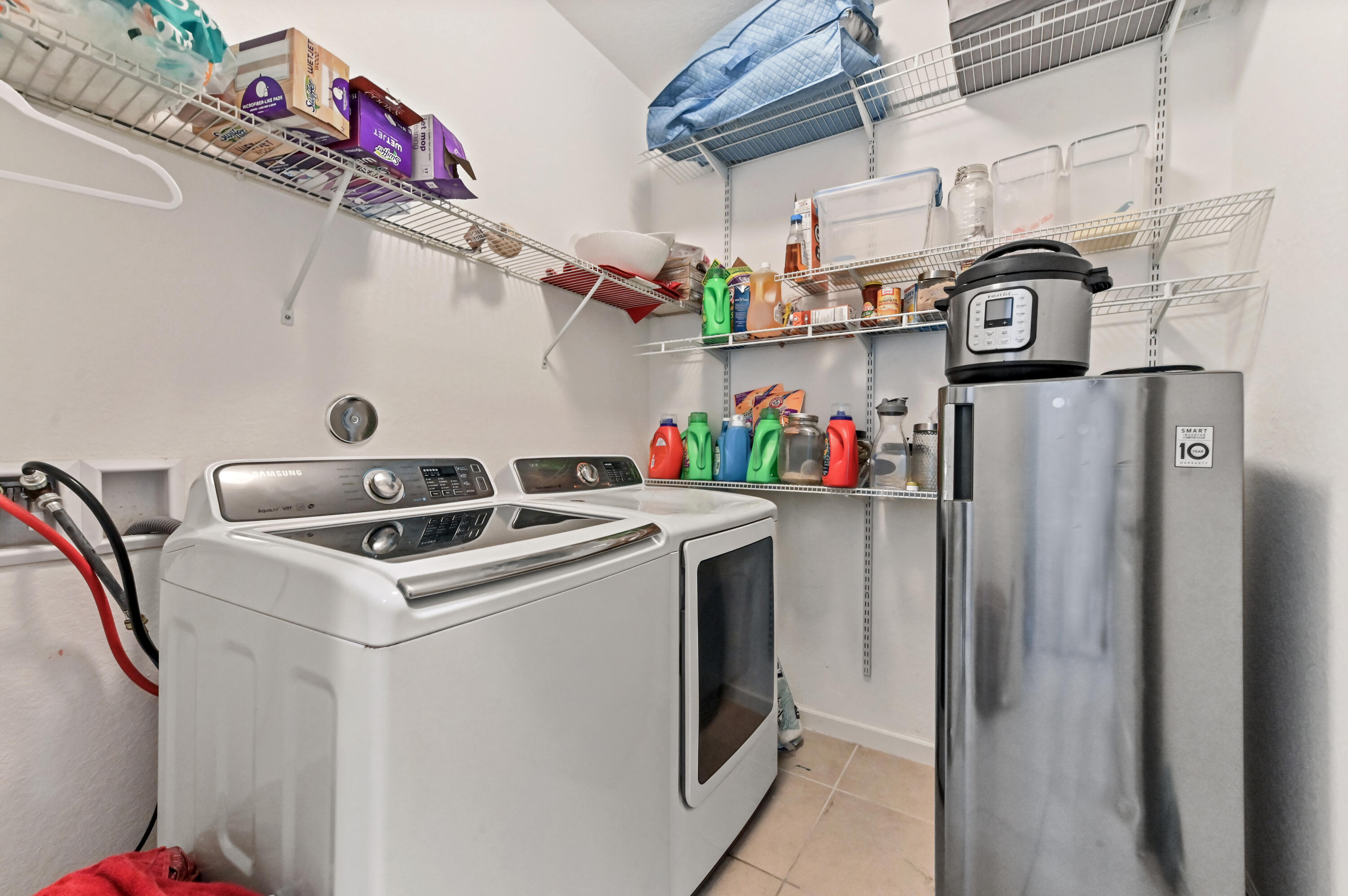 4848 Pond Pine Way Greenacres, FL 33463 - Photo 4 of 14 a utility room with dryer and washer