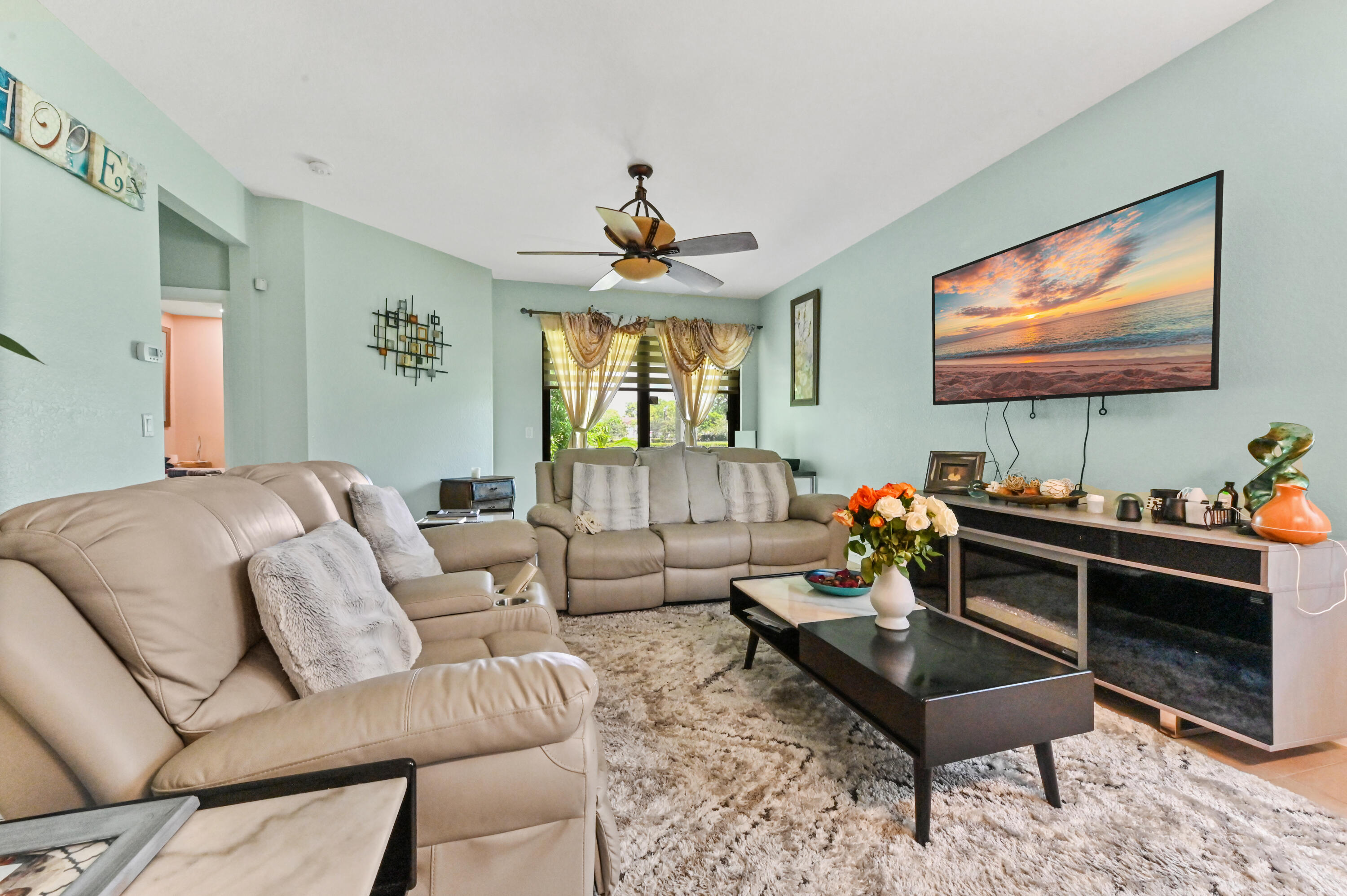 4848 Pond Pine Way Greenacres, FL 33463 - Photo 8 of 14 a living room with furniture a window and a flat screen tv