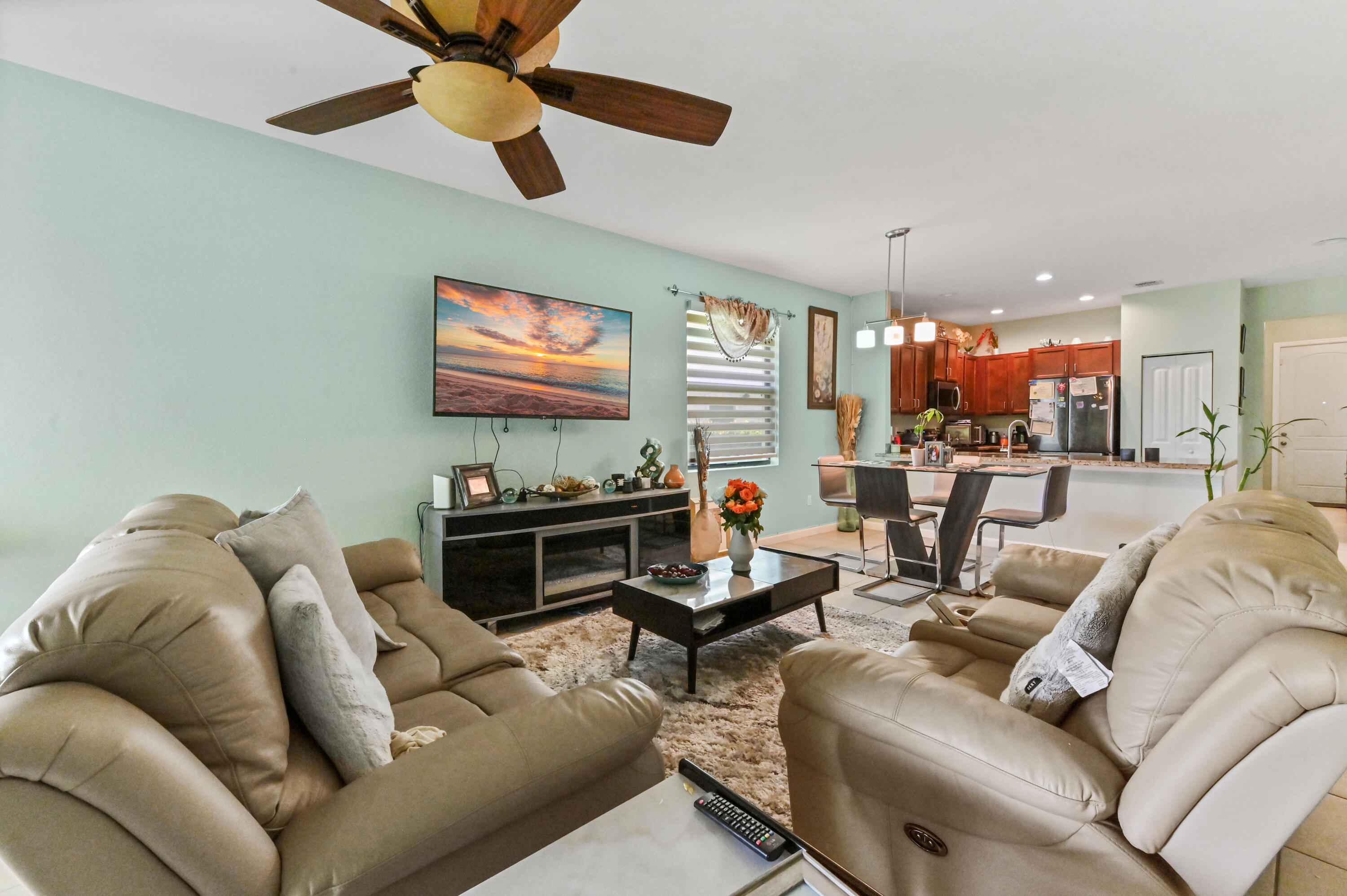 4848 Pond Pine Way Greenacres, FL 33463 - Photo 9 of 14 a living room with furniture ceiling fan and a rug