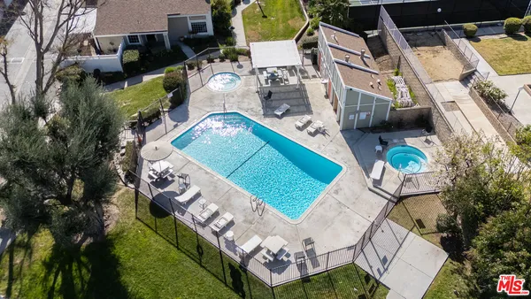an aerial view of a house with garden space and street view
