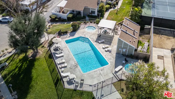 an aerial view of a house with a garden and swimming pool
