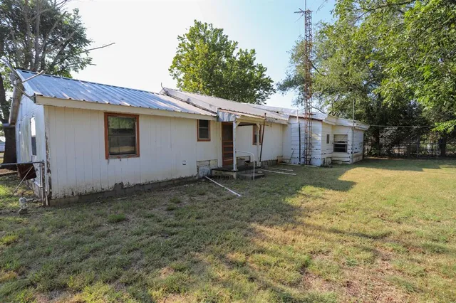 a backyard of a house with yard and garage