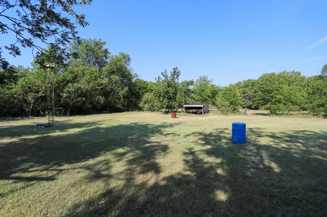 a view of a field with an trees