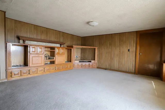 a view of a livingroom with an empty room and fire place
