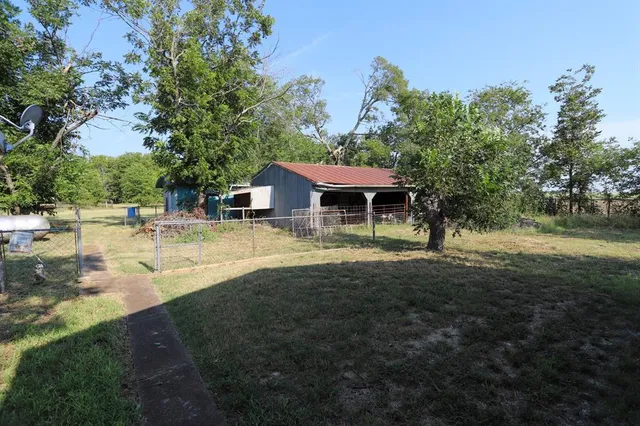 a view of a house with yard and sitting area
