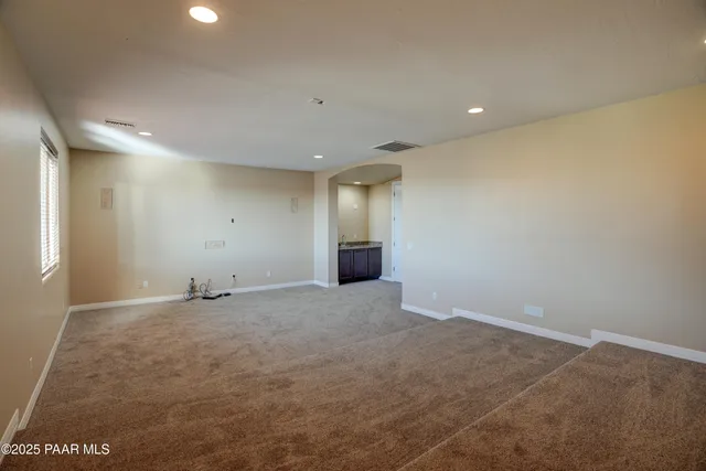 an empty room with an entrance to other room