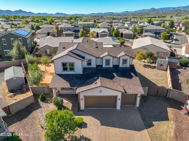an aerial view of a house with a big yard