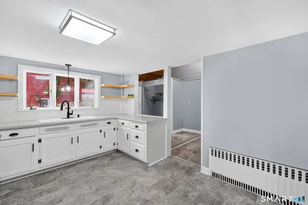 a view of kitchen with cabinets