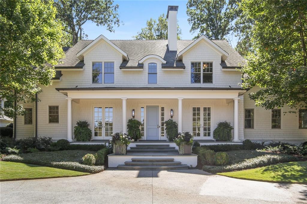 189 Robin Hood Road Northeast Atlanta, GA 30309 - Photo 1 of 28 a view of a white house with couches potted plants and a large tree