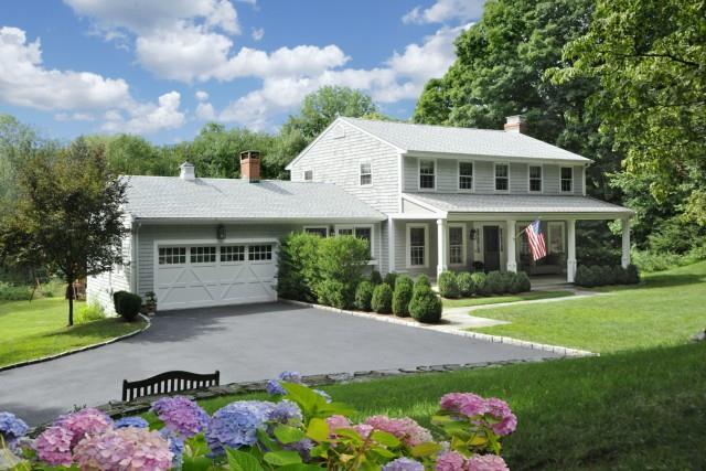 a front view of house with yard and green space