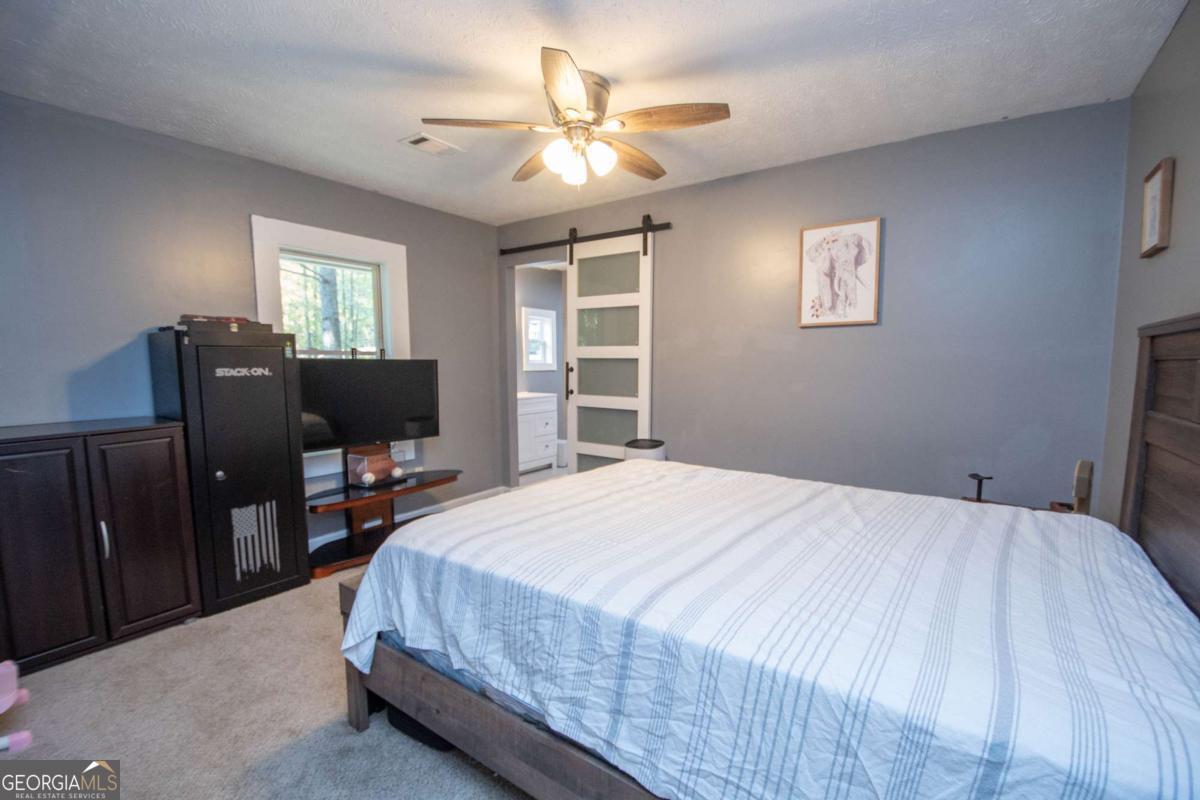 1104 Alverson Road LaGrange, GA 30241 - Photo 12 of 25 a bedroom with a bed and a flat screen tv