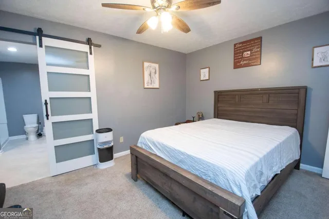 a bed sitting in a bedroom and view of closet