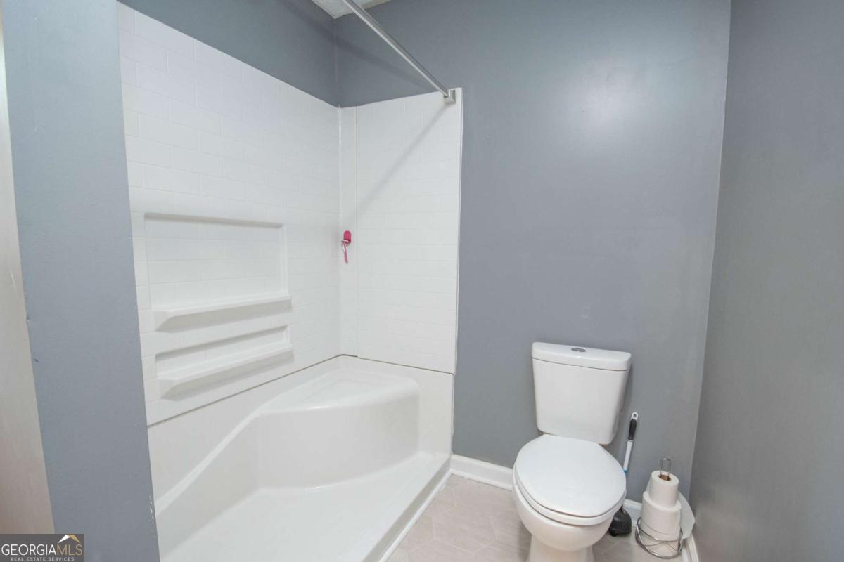 1104 Alverson Road LaGrange, GA 30241 - Photo 15 of 25 a white toilet sitting next to a bath tub