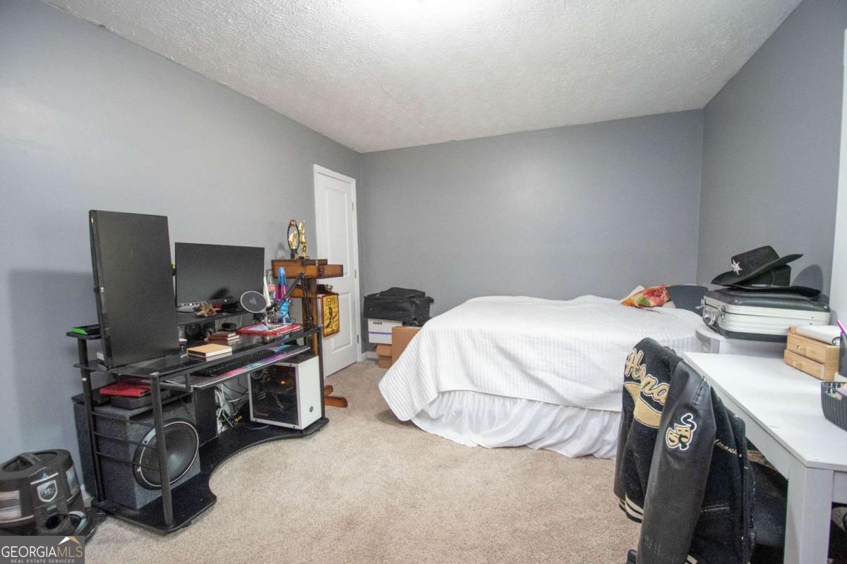 1104 Alverson Road LaGrange, GA 30241 - Photo 16 of 25 a bedroom with a bed and a computer on a desk