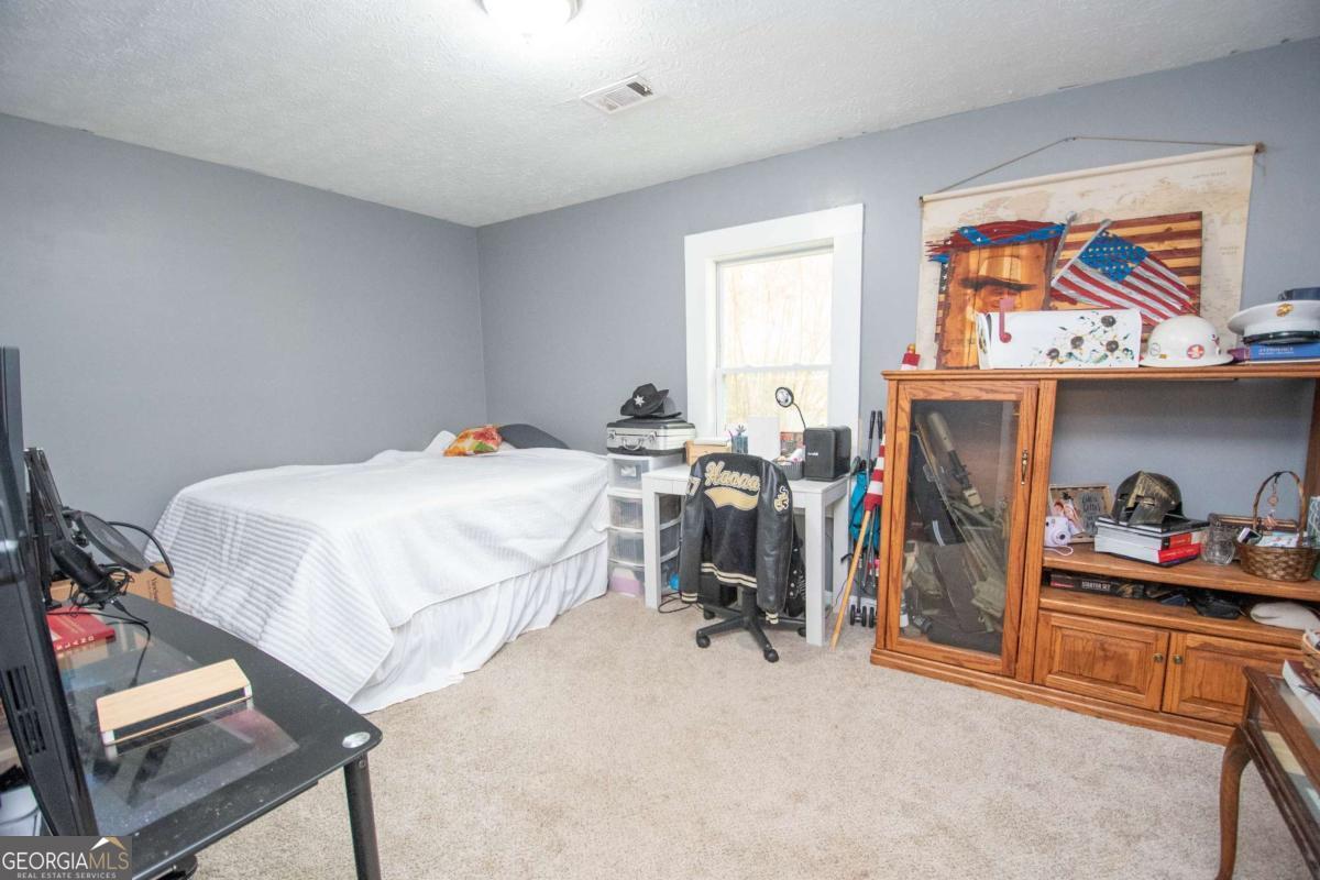 1104 Alverson Road LaGrange, GA 30241 - Photo 17 of 25 a bedroom with bed and a window