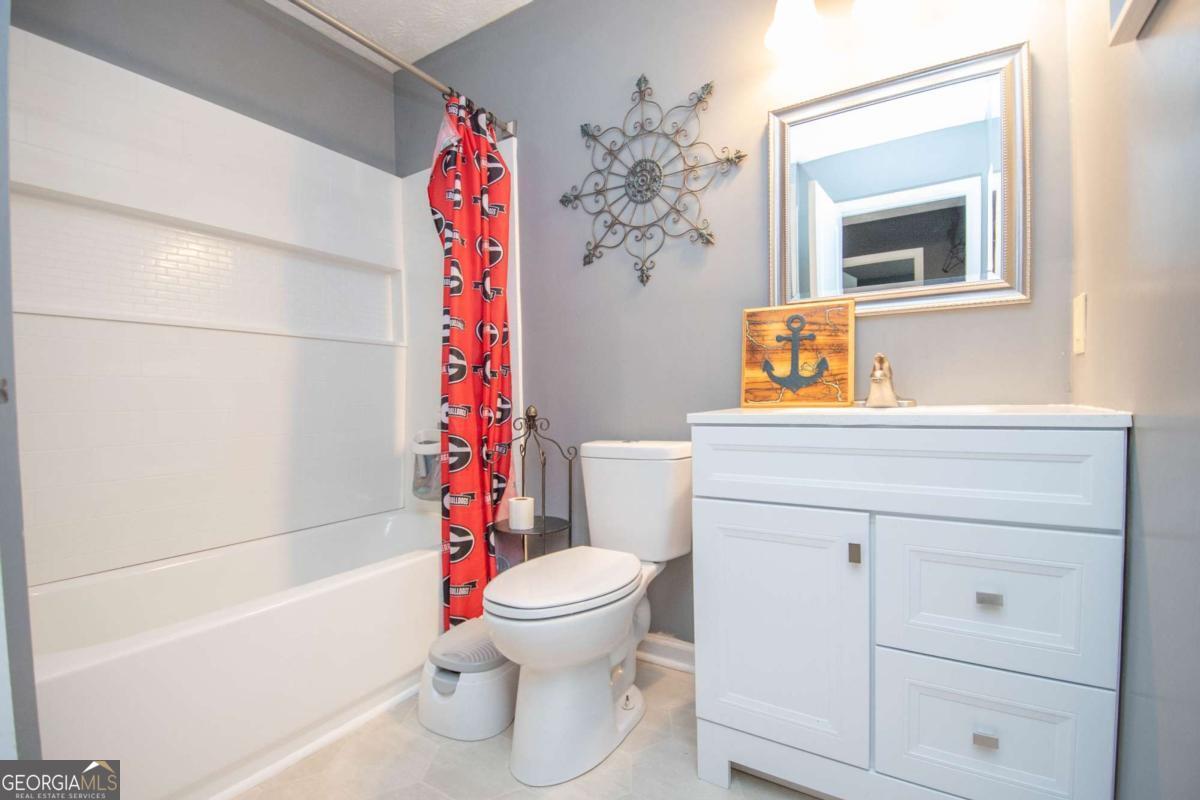 1104 Alverson Road LaGrange, GA 30241 - Photo 18 of 25 a bathroom with a sink toilet and shower