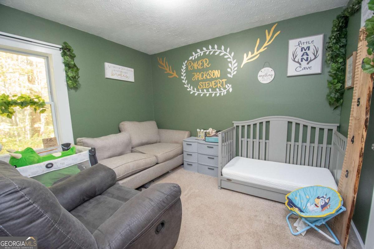1104 Alverson Road LaGrange, GA 30241 - Photo 19 of 25 a bedroom with furniture and a window