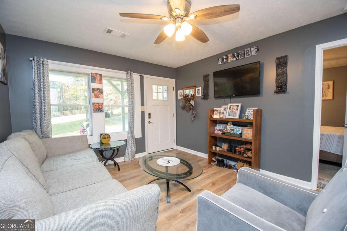 1104 Alverson Road LaGrange, GA 30241 - Photo 3 of 25 a living room with furniture and a flat screen tv