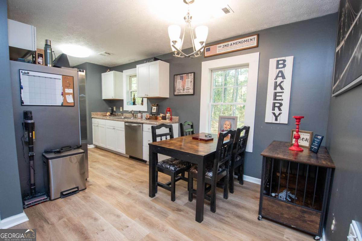 1104 Alverson Road LaGrange, GA 30241 - Photo 6 of 25 a view of a dining room with furniture and chandelier