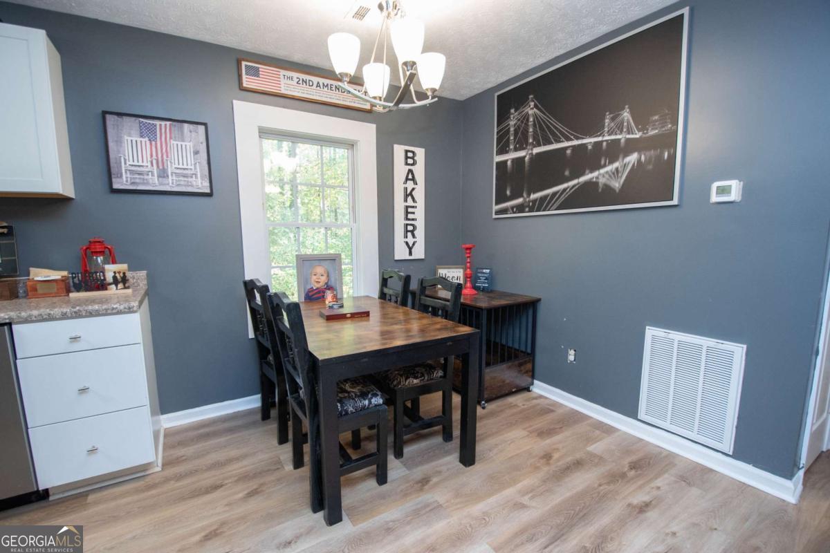 1104 Alverson Road LaGrange, GA 30241 - Photo 7 of 25 a view of a dining room with furniture window and wooden floor