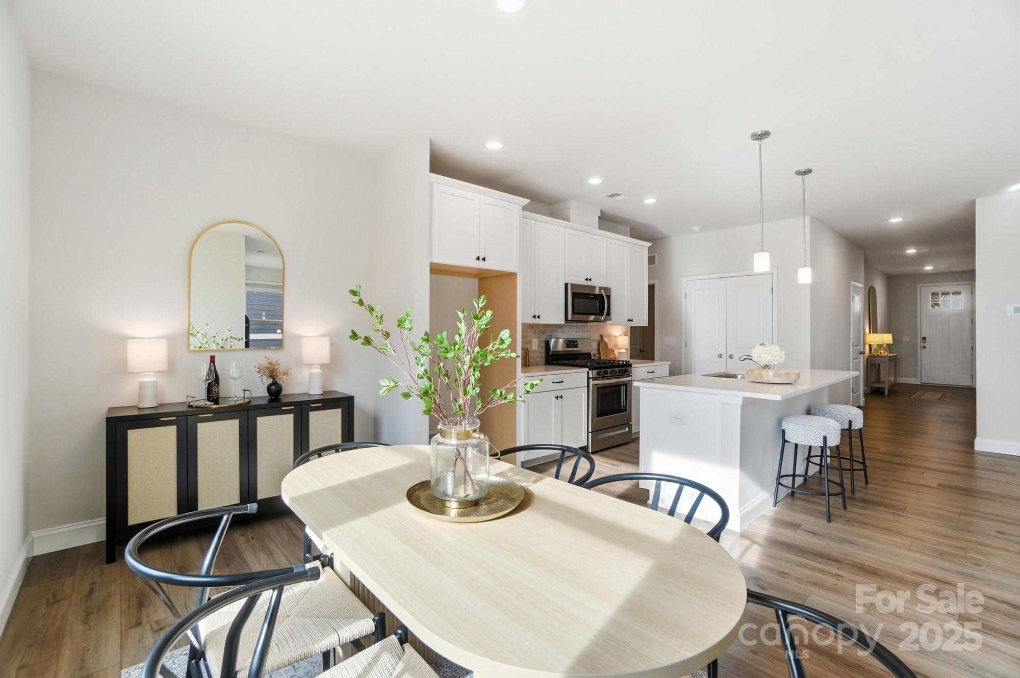 256 Hamrick Road, Unit 12 Cramerton, NC 28056 - Photo 21 of 41 a view of a dining room with furniture and wooden floor