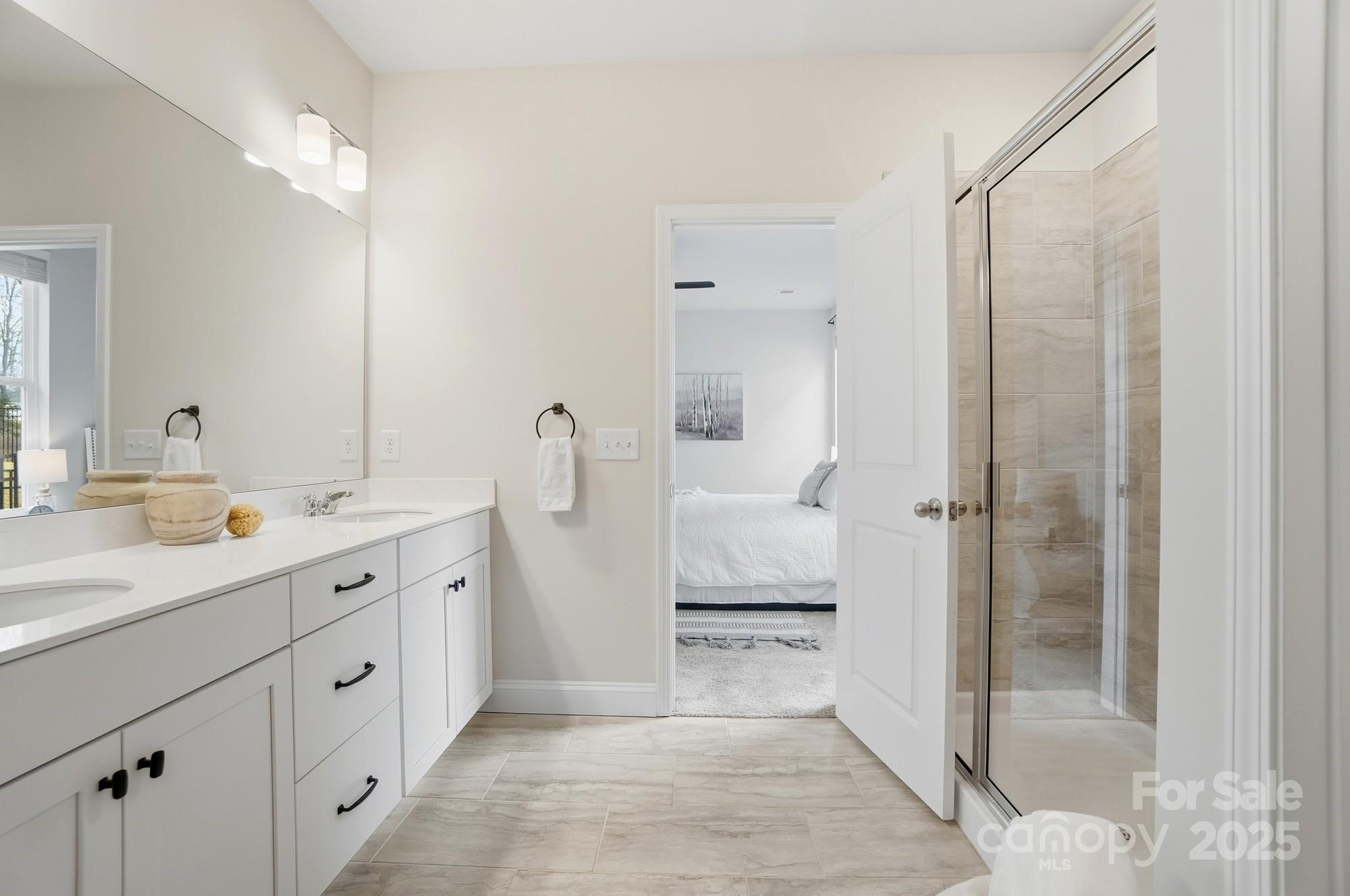 256 Hamrick Road, Unit 12 Cramerton, NC 28056 - Photo 29 of 41 a spacious bathroom with a double vanity sink a mirror and a shower