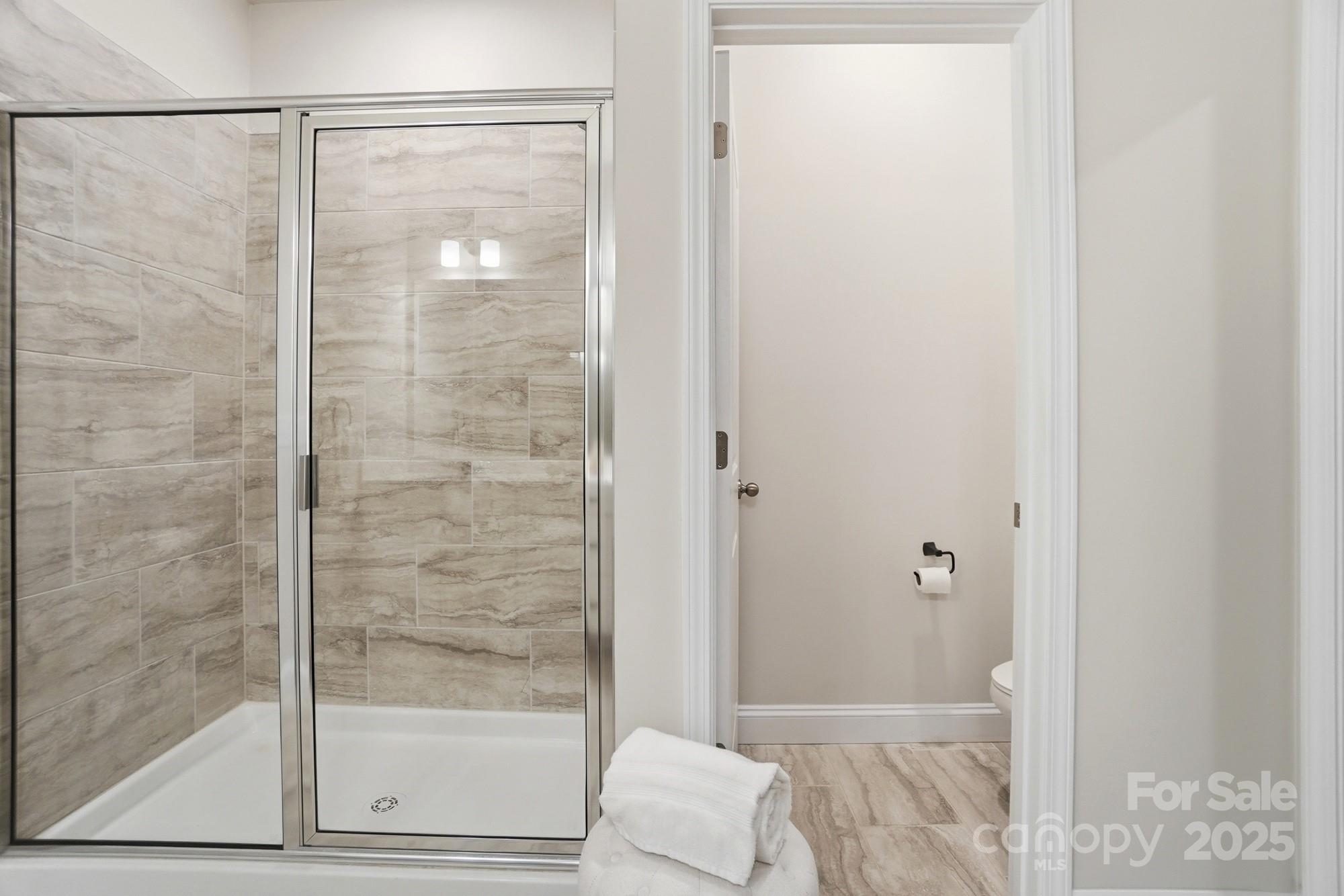 256 Hamrick Road, Unit 12 Cramerton, NC 28056 - Photo 30 of 41 a bathroom with a glass shower door