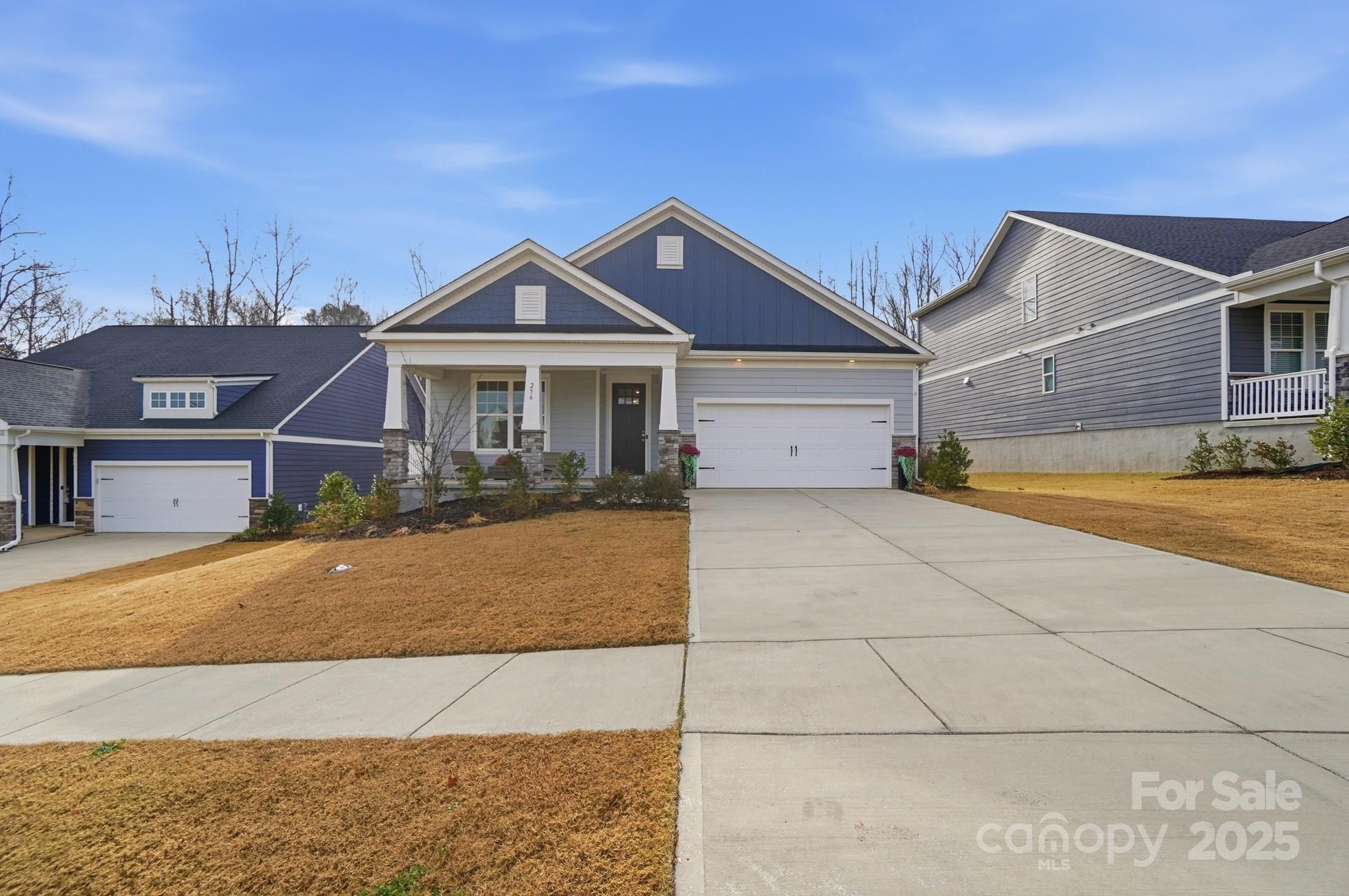 256 Hamrick Road, Unit 12 Cramerton, NC 28056 - Photo 3 of 41 a front view of a house with a yard and garage