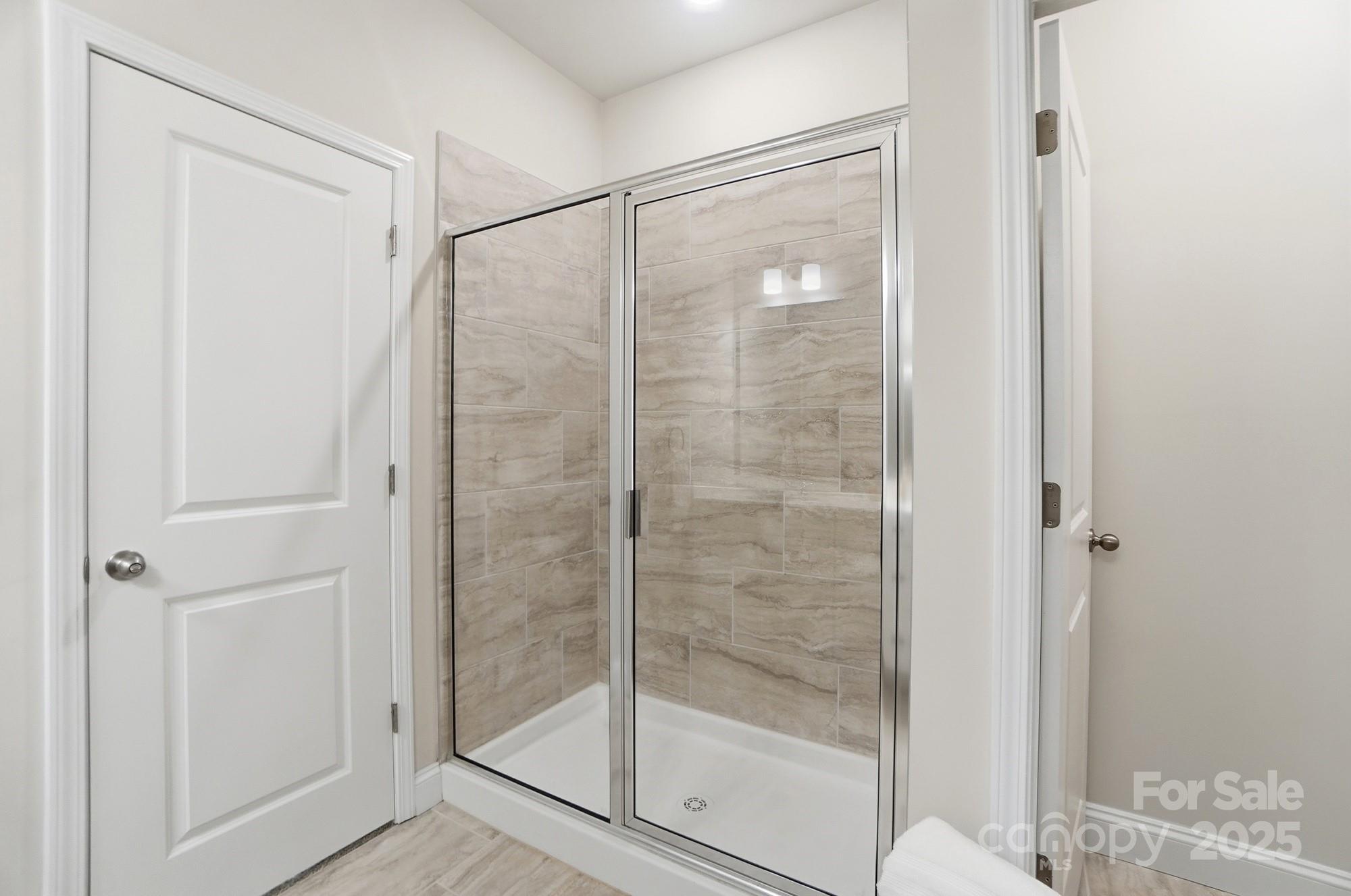 256 Hamrick Road, Unit 12 Cramerton, NC 28056 - Photo 31 of 41 a bathroom with a glass shower door