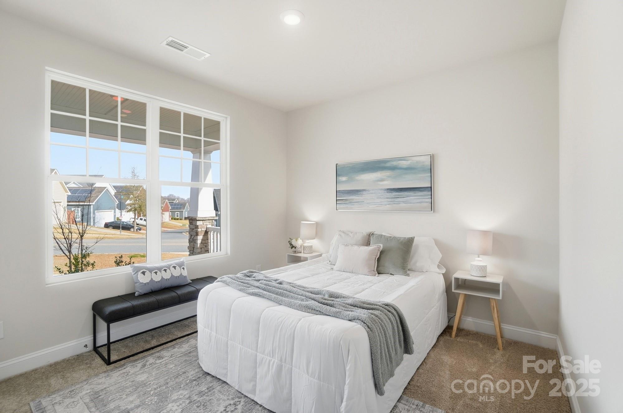 256 Hamrick Road, Unit 12 Cramerton, NC 28056 - Photo 33 of 41 a bedroom with a bed and a painting on the wall