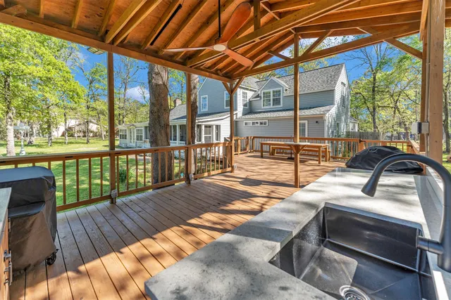 a view of a patio with wooden floor and iron stairs