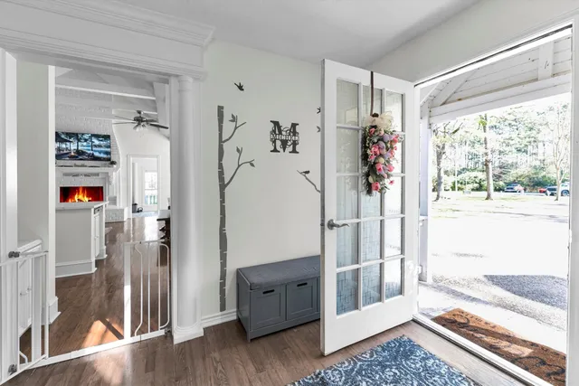 a view of a hallway with wooden floor and windows