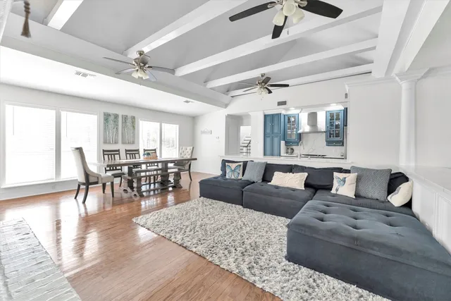 a living room with furniture and wooden floor