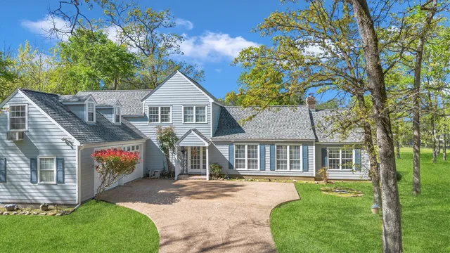 a front view of a house with a garden and deck