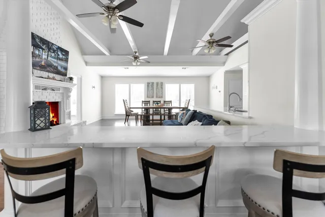 a kitchen with a dining table chairs cabinets and stainless steel appliances