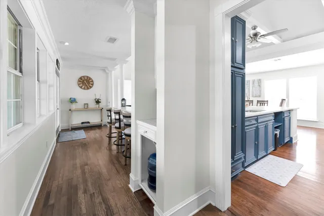 a view of a living room with furniture and wooden floor