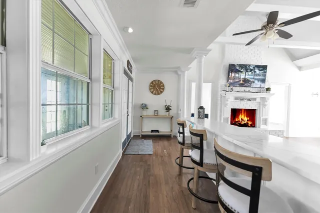 a living room with furniture a fireplace and a window