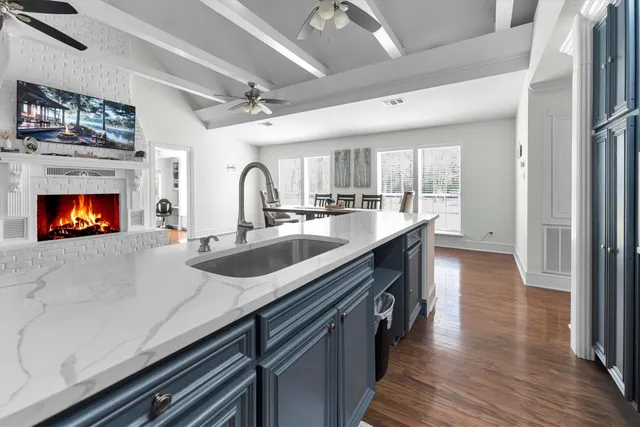 a kitchen with granite countertop a sink cabinets a counter top space and stainless steel appliances