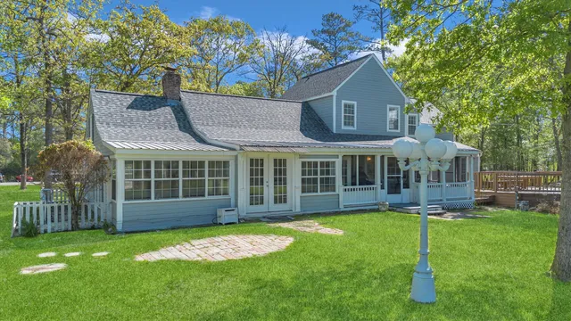 a view of a house with a yard and sitting area
