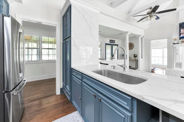 a en suite bathroom with a granite countertop sink mirror and bathtub