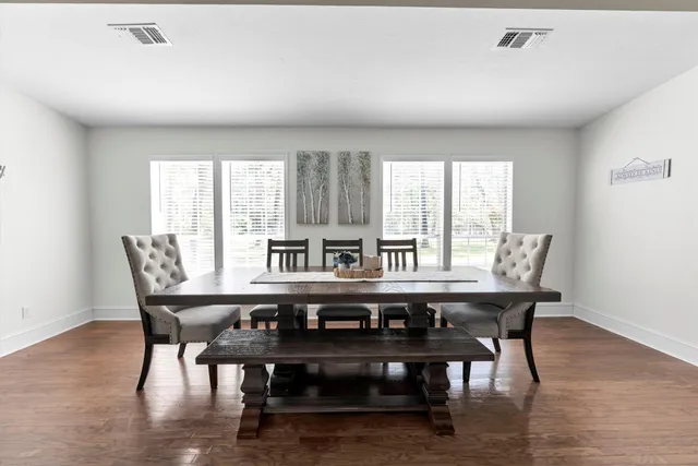 a view of a dining room with furniture and window