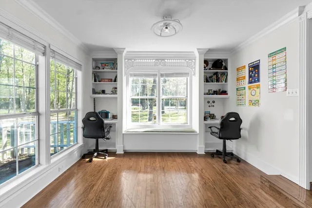a living room with furniture and a floor to ceiling window