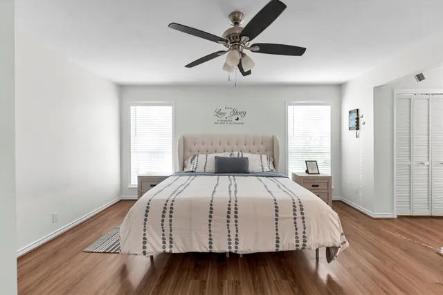 a bedroom with a bed and wooden floor