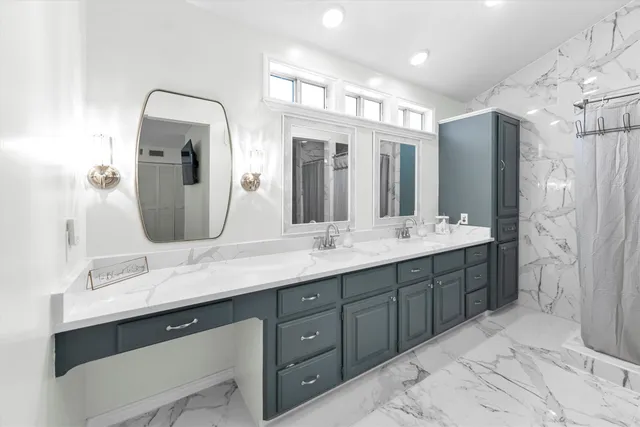 a bathroom with a double vanity sink and a mirror