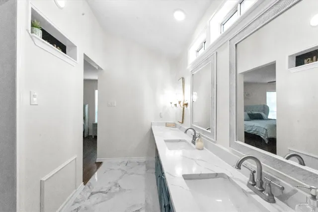 a bathroom with a double vanity sink and mirror