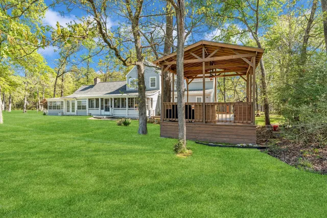 a view of a house with a backyard